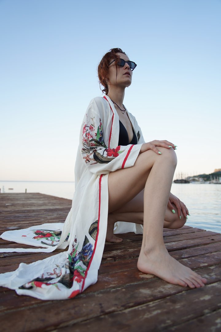 White floral kimono on a wooden pier by the sea