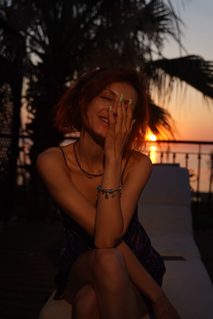 Laughing portrait at sunset under palm leaves